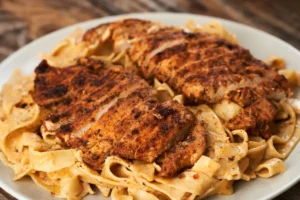 Serving creamy Cajun Chicken Pasta. Variations of Cajun Alfredo Pasta with vegetables.