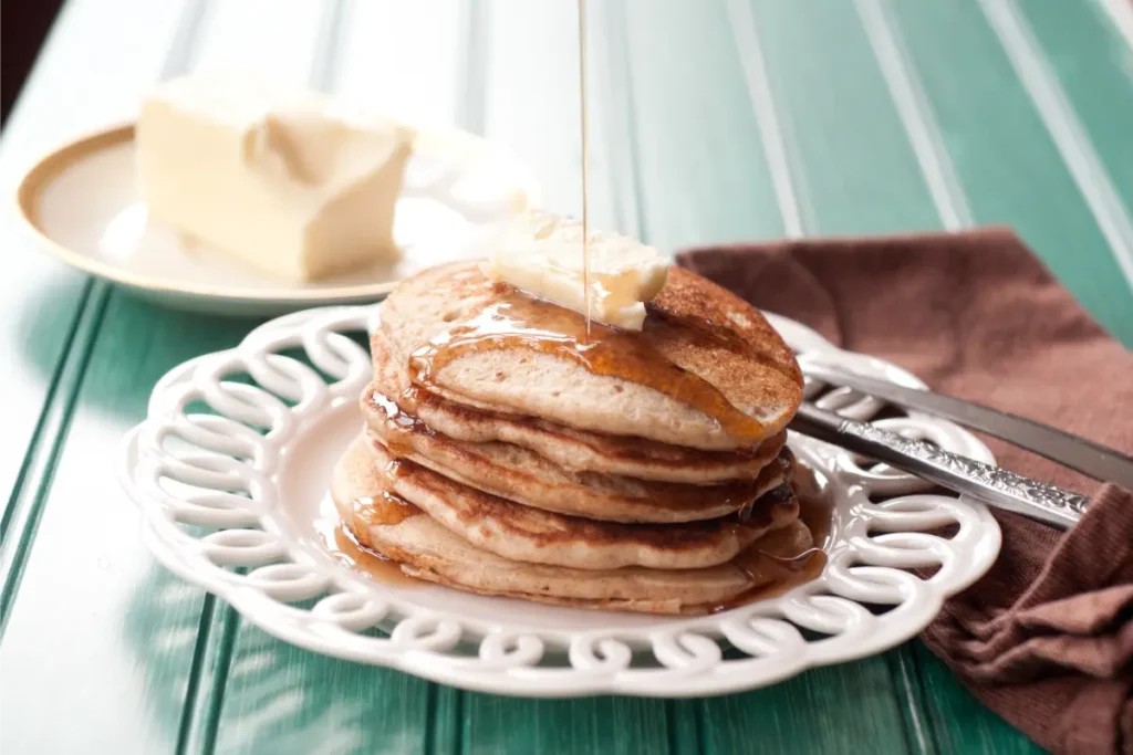 Fluffy sourdough discard pancakes served with fresh berries and syrup.